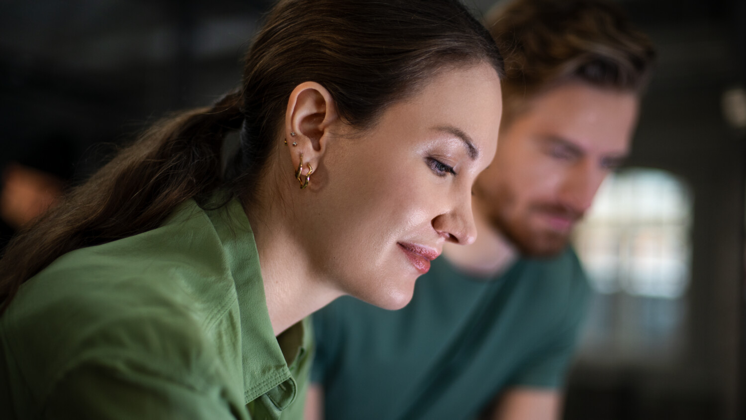 female professional discussing work with colleague in office setting